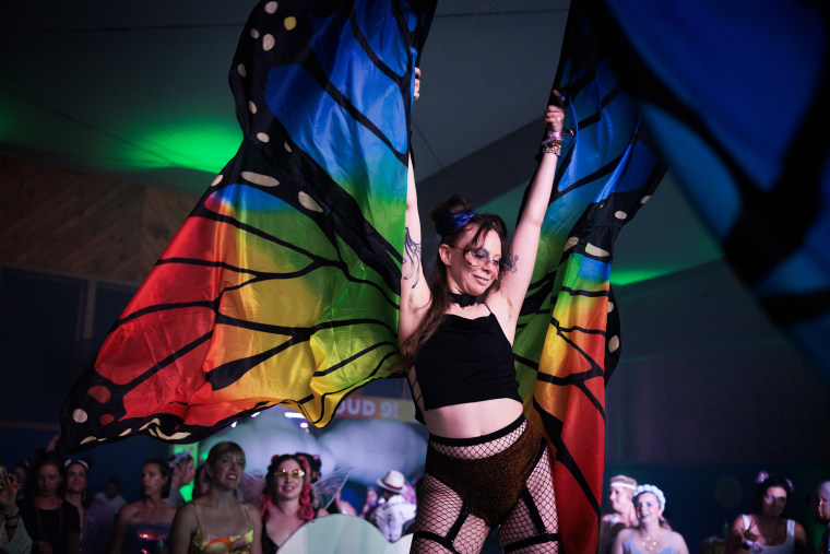 Elise Bish walks on a runway during Breastival.