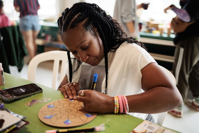 Violeta Reynolds, 41, draws during arts and crafts.