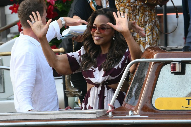 US talk show host Oprah Winfrey waves as she gets on a taxi boat to leave the Gritti Palace Hotel ahead of the wedding of Amazon's founder Jeff Bezos with Lauren Sanchez in Venice on June 26, 2026. Celebrities in superyachts sail into Venice this week for the three-day wedding party of Amazon tycoon Jeff Bezos and Lauren Sanchez, despite irate locals who say the UNESCO city is no billionaire's playground. The tech magnate and journalist have reportedly invited about 200 guests to their multi-million dollar nuptials in the Italian city, which are expected to kick off on June 26 and end Saturday with a ceremony at a secret location. 