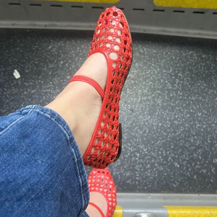 Woman wearing red woven flats