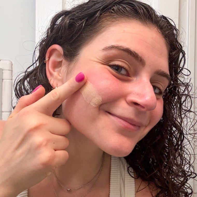 NBC Select reporter Zoe Malin blends the tint into the skin using her fingers for a smooth, matte finish.