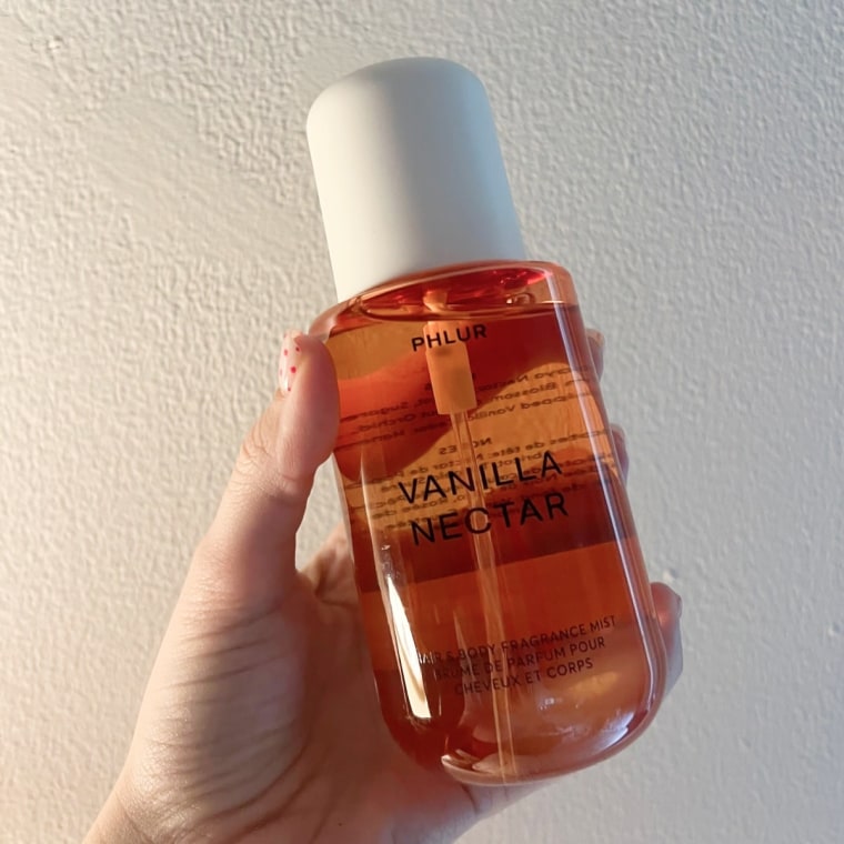 Body mist on white wall background