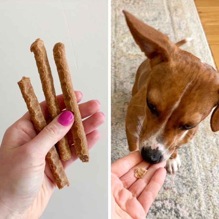 A hand holding three Wholehearted Soft & Slim Stick Treats, left, and a brown and white puppy getting a piece of the treat, right.