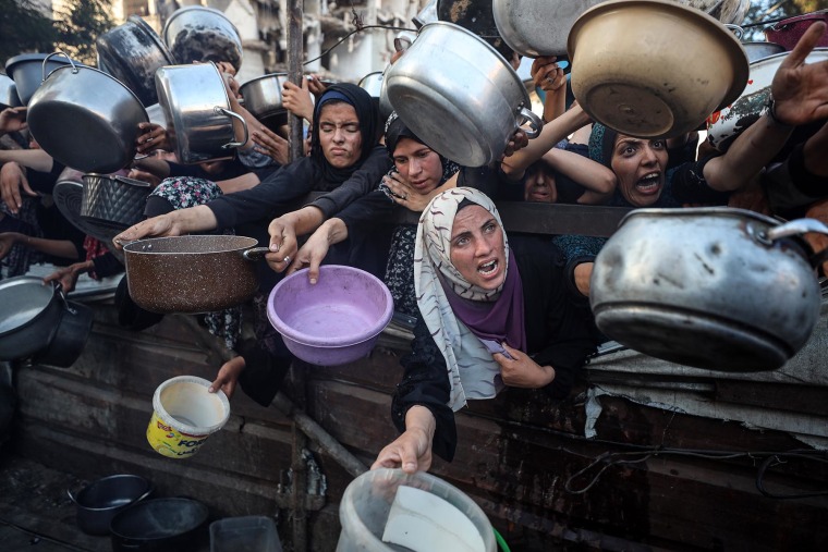 Palestinians stitchery astatine a nutrient distribution constituent successful Gaza City, connected July 20, 2025.