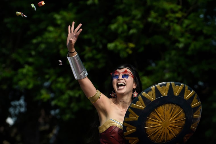 A participant throws candy during the Fourth of July parade in Prattville, Ala., on Friday.