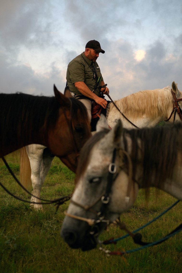 Matt McCrury sits on a horse, two other horses are in front of him in the foreground