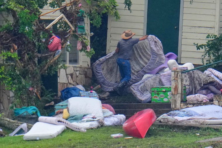A person removes bedding