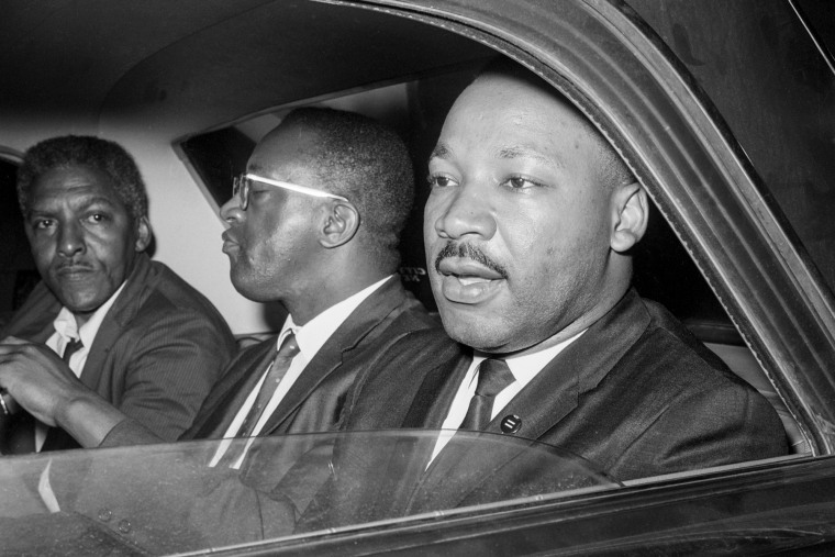 From left, Bayard Rustin, Bernard Lee, and Martin Luther King Jr in the backseat of a car, photo taken from the window closest to Martin Luther King