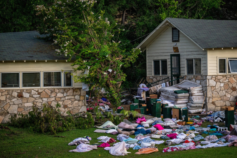 Children's belongings piled up outside buildings at Camp Mystic on July 7, 2025 in Hunt, Texas.