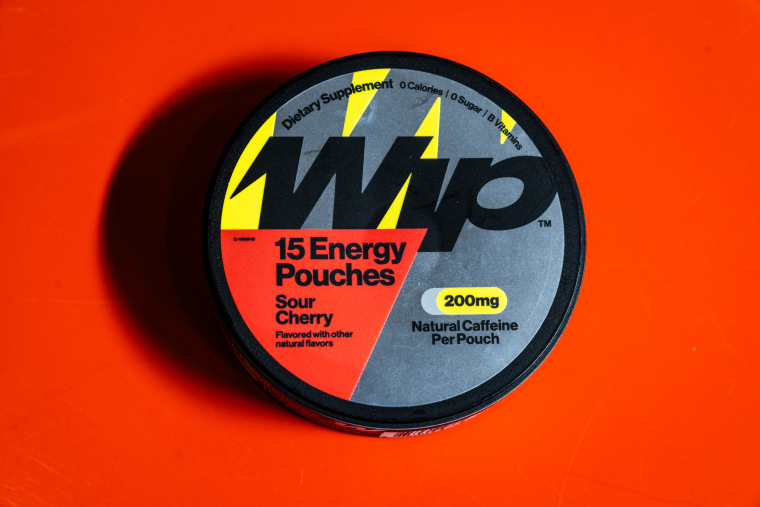 A circular Wip container is displayed on a red table