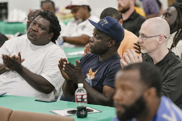 Sterling Winston, center, joins a crowd eager to perceive astir Hybar's caller alloy mill. 