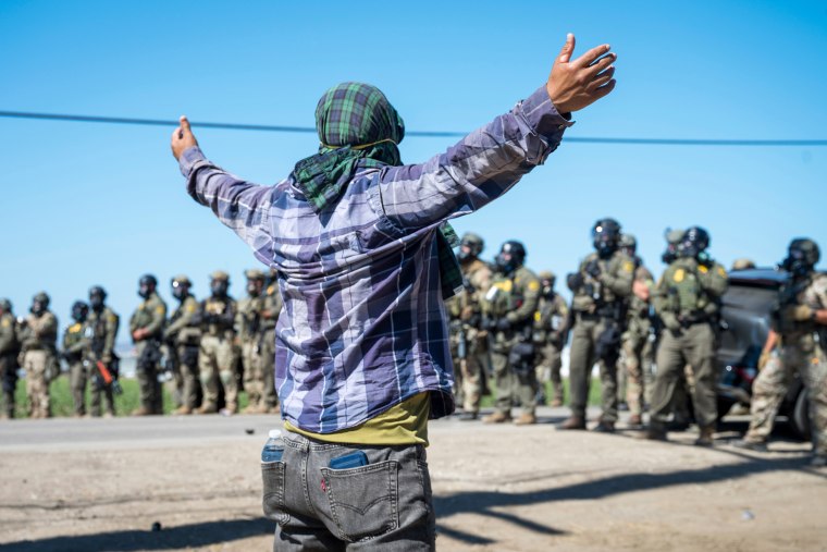 A protester in front of federal immigration agents