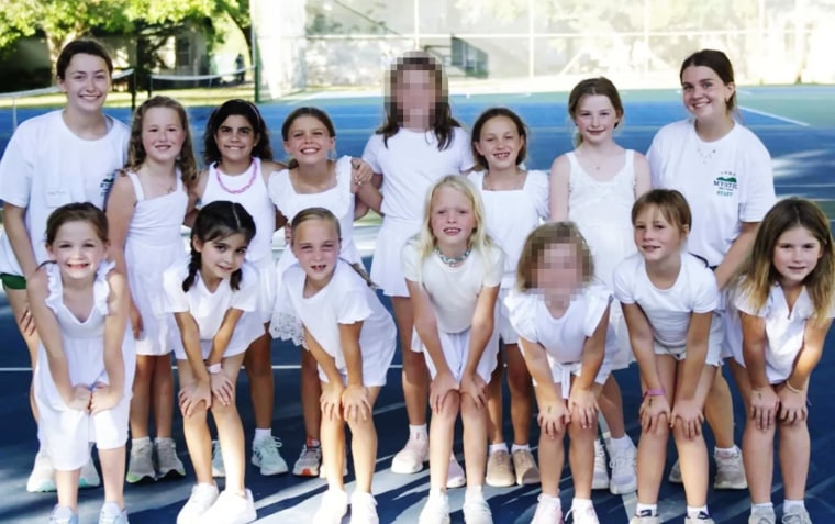 Girls in the Bubble Inn cabin at Camp Mystic pose for a group photo with their counselors. NBC News has blurred the faces of two girls whose identities could not be independently verified.