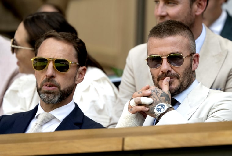 David Beckham with former England national football team manager Gareth Southgate during the men's singles first-round match. 