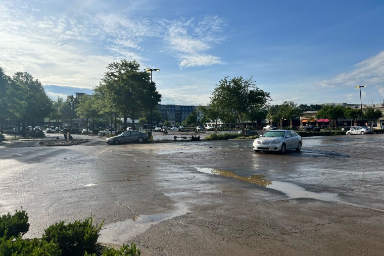 The parking lot of the Eastgate Mall with water puddles