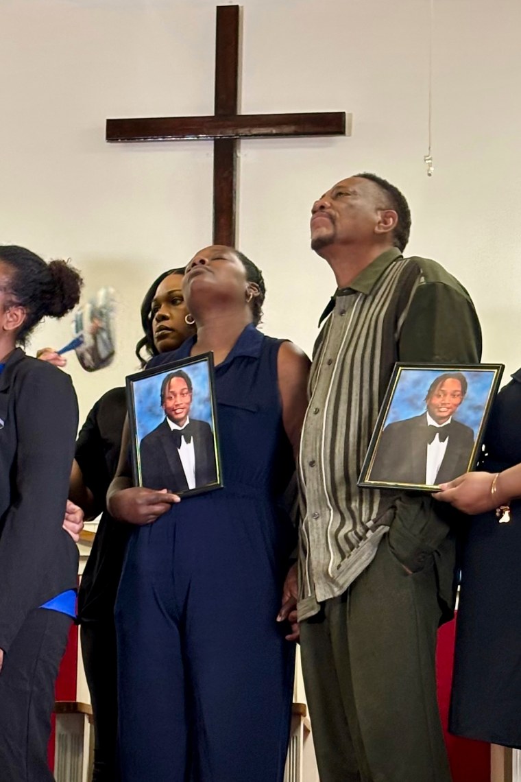 Vivian Sterling, holding a photo of her son and William Peoples