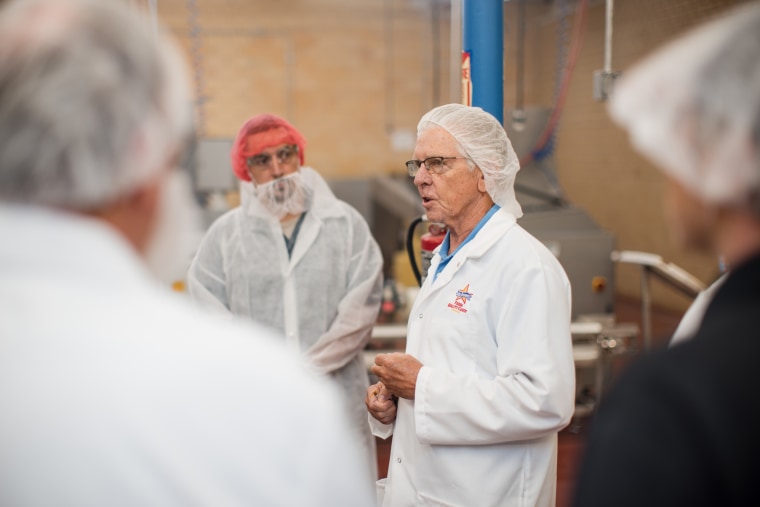 Eric Atkinson, CEO of Atkinson Candy Company, speaks with visitors to its factory in Lufkin, Texas.