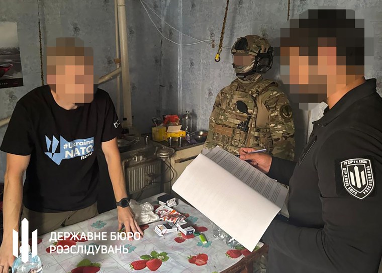 Vitaliy Shabunin, left, during a police raid on a military residence in Kharkiv on Friday.