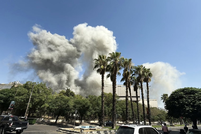 Smoke billows following Israeli strikes near the Syrian army and defence ministry headquarters in Damascus on July 16, 2025.