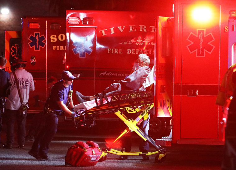 A patient is loaded onto an ambulance after a fire at the Gabriel House