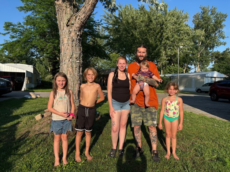 Image: Julia Ling and Michael Miller, center, were at a Walmart in Traverse City, Mich., with four of their children when a man allegedly stabbed 11 people on July 26, 2025.
