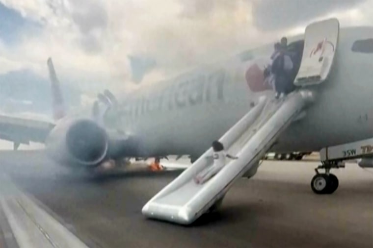 Passengers evacuating an American Airlines jet at Denver International Airport on emergency slides in July.