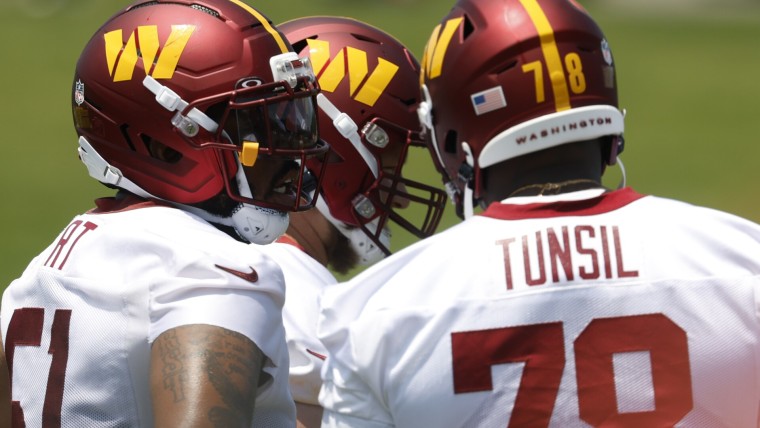 Jun 10, 2025; Ashburn, VA, USA; Washington Commanders offensive linemen stand on the field between drills on day one of minicamp at Commanders Park. Mandatory Credit: Geoff Burke-Imagn Images
