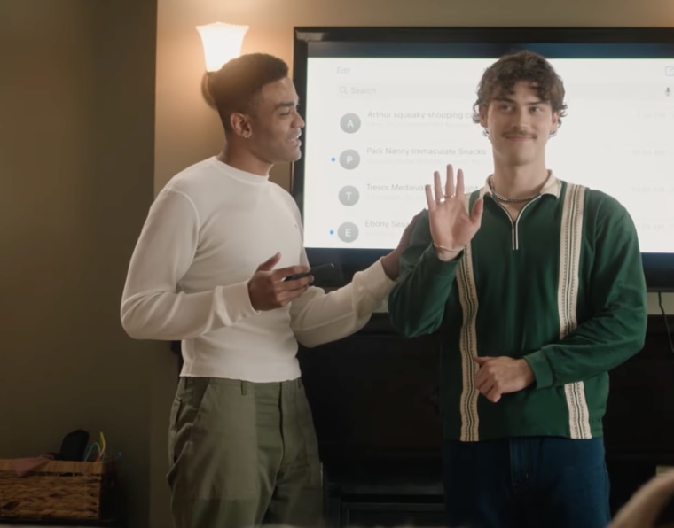 Anton and Paul Baker stand in front of a shared screen of Anton's many, many unread texts.