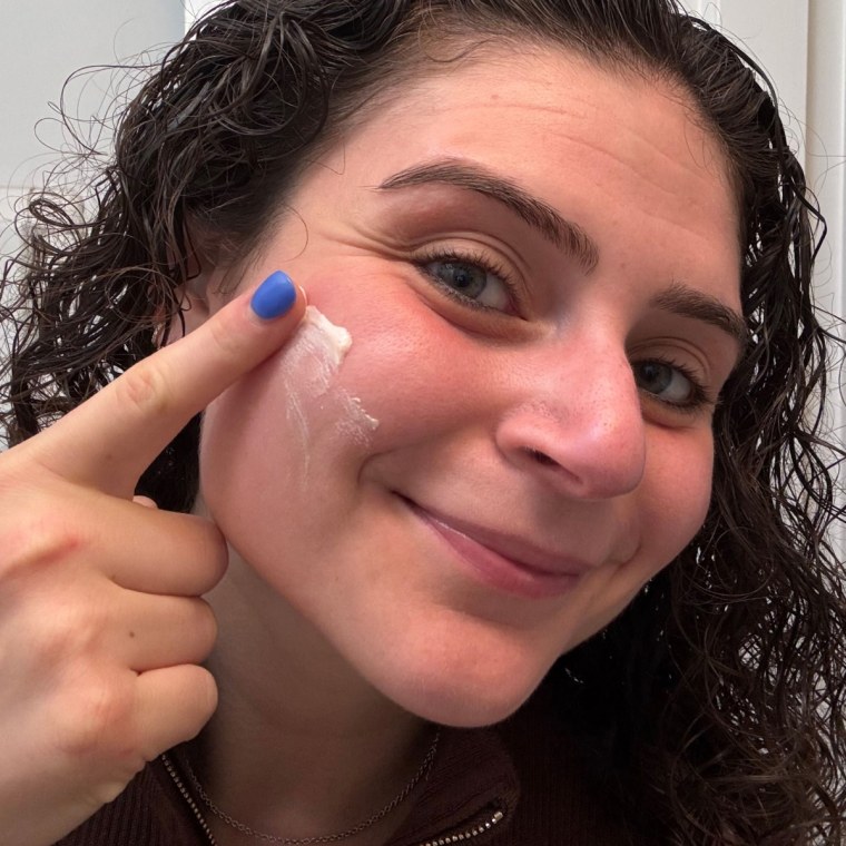 Woman applying Rare Beauty primer to her face