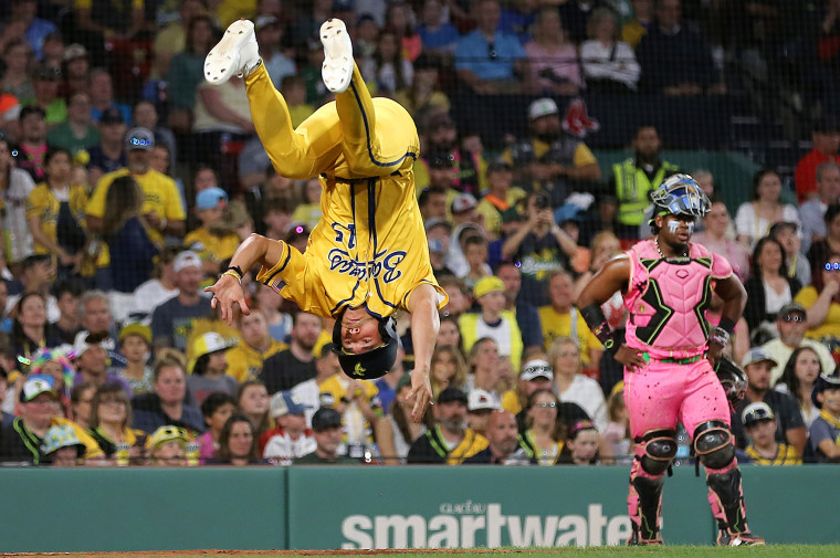 Savannah Bananas player RobertAnthony Cruz does a flip at home plate in the sixth inning after his team scored a run.