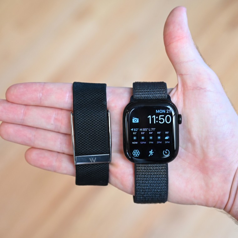 A close up of the Whoop MG and Apple Watch Series 10 in the hand of the writer.