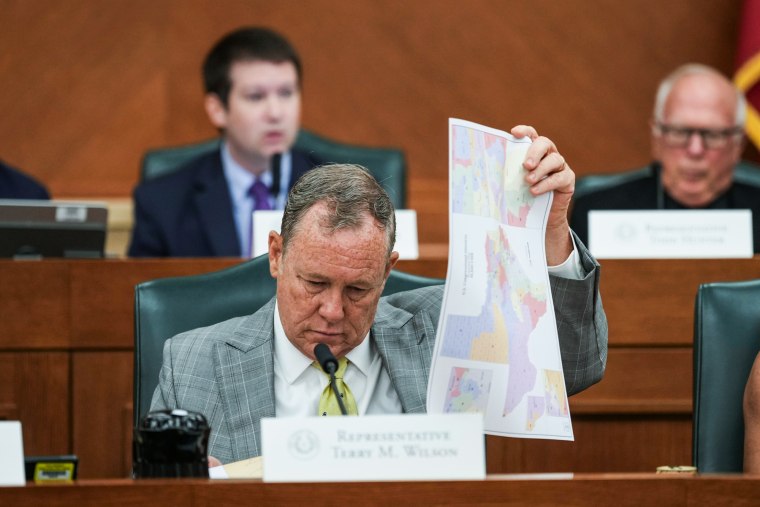 Terry M. Wilson looks through maps during a public hearing