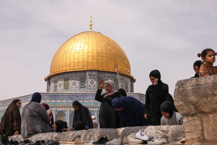 The Al Aqsa mosque dome and women praying.