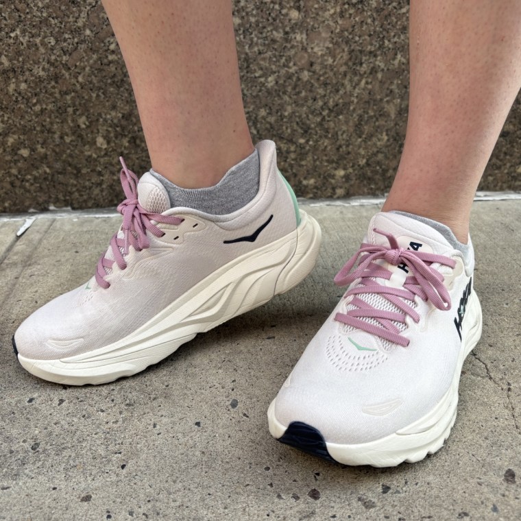 Woman wearing lavender HOKA Arahi 8 walking shoes