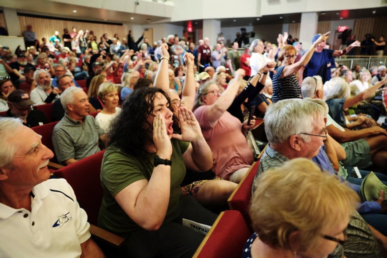 The crowd reacts as Rep. Mike Flood, R-Neb., answers questions from constituents during a town hall in Lincoln on Aug. 4, 2025.
