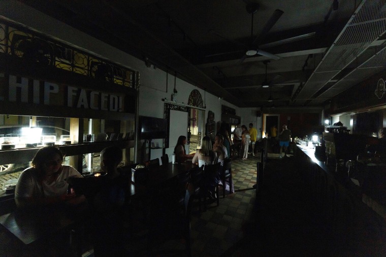 Customers in a restaurant in Old San Juan lit by battery-powered lanterns during an islandwide power outage in April.