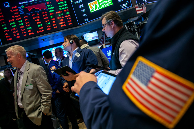 Traders work on the floor of the NYSE