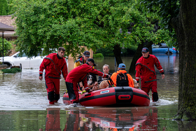 Residents in boats during flooding.