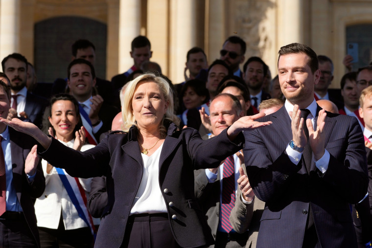 Marine Le Pen and Jordan Bardella at a party national rally