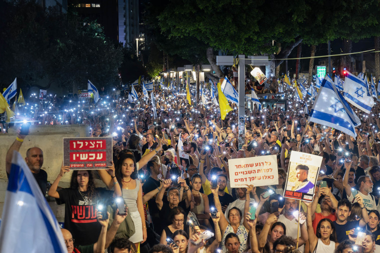 Protesters with flashlights on their phones during a demonstration in Tel Aviv.