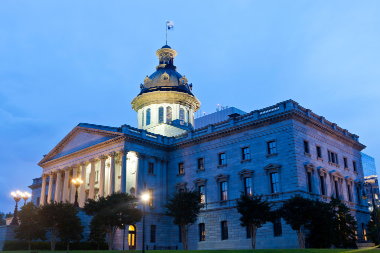 The state house  lit up at night.