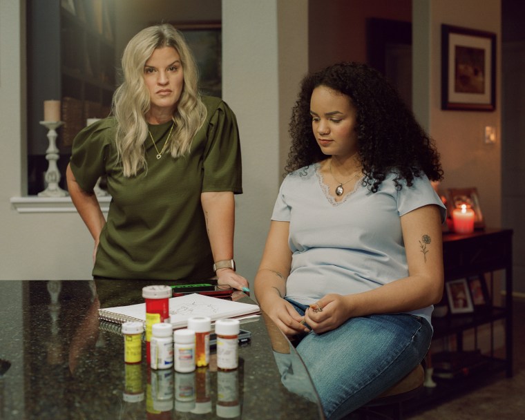 Nala White, right, and her mother, Christine Byers at a kitchen counter with medications on top