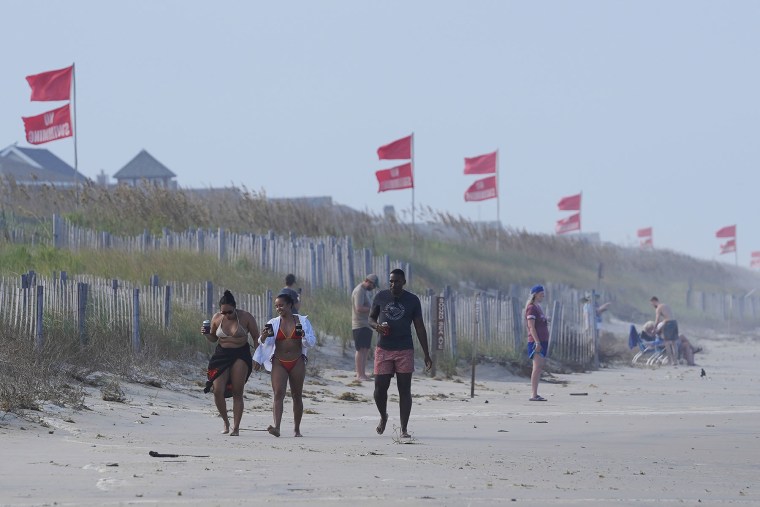 Red flags, indicating swimming is prohibited, are raised at the beach in Duck, N.C., on Aug. 19, 2025.