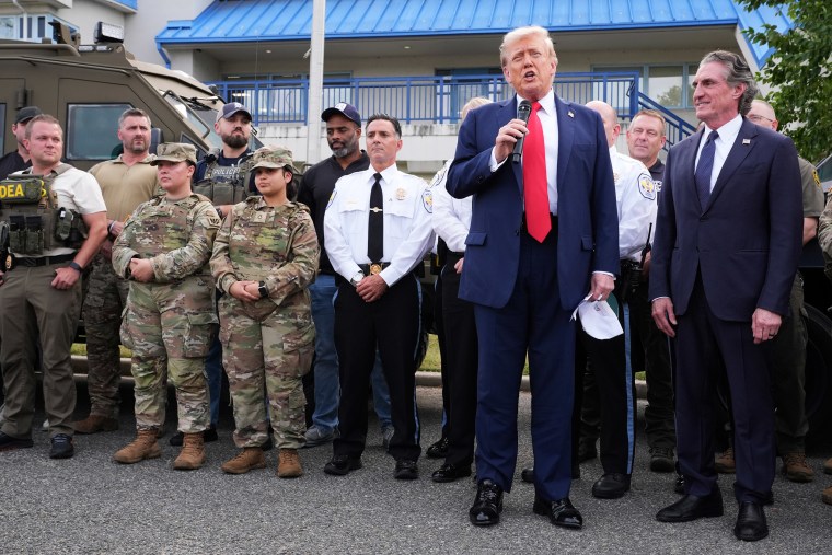 President Donald Trump with members of law enforcement and National Guard soldiers