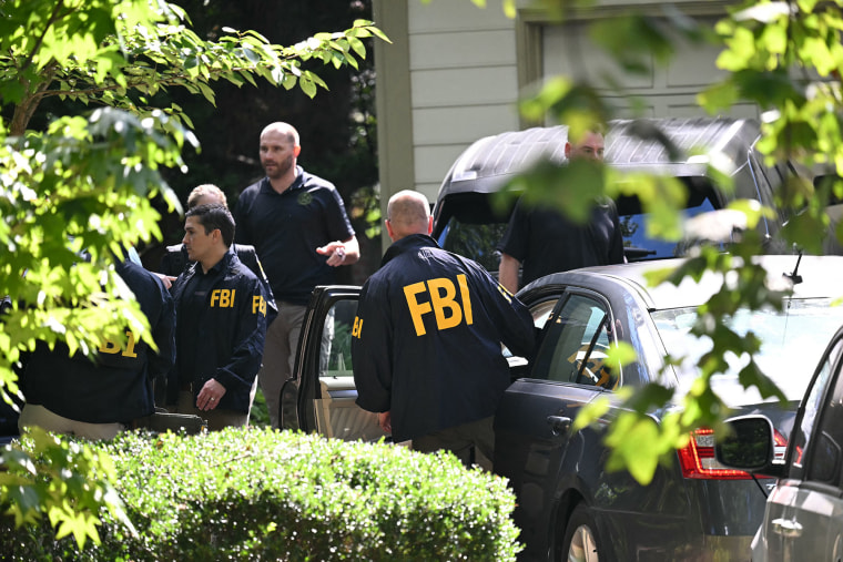 Agents outside John Bolton's house after the FBI conducted a court-authorized search on Aug. 22, 2025 in Bethesda, Md. 