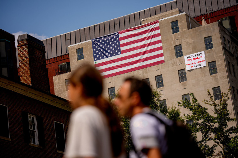 Image: Giant Sign And American Flag On Building Near White House Praises Trump