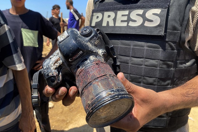 A journalist holds the blood-covered camera belonging to Palestinian photojournalist Mariam Dagga