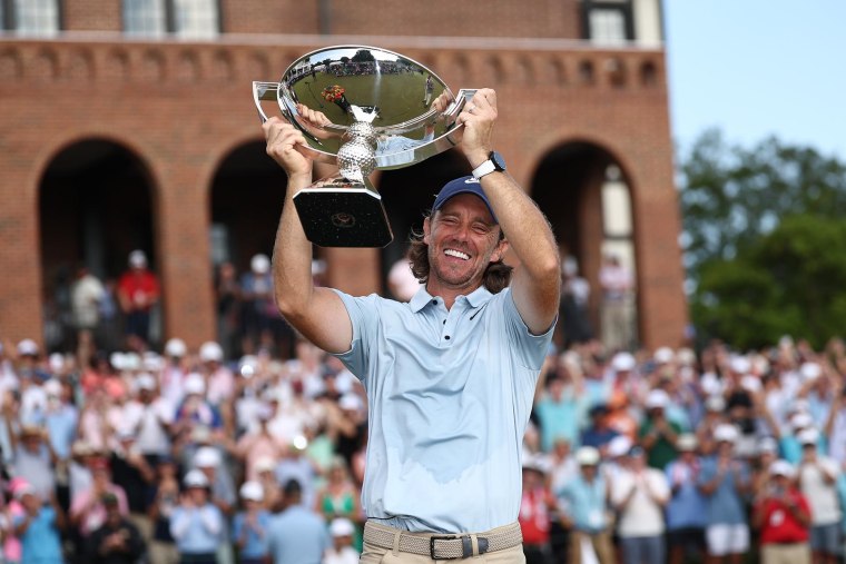 Tommy Fleetwood celebrates pinch nan Fedex Cup trophy 
