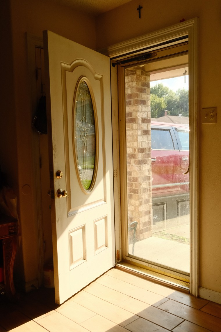 Lakeita Williams was rescued by canoe in the front yard of her mother's home. The cross above the door has remained there since before the storm.