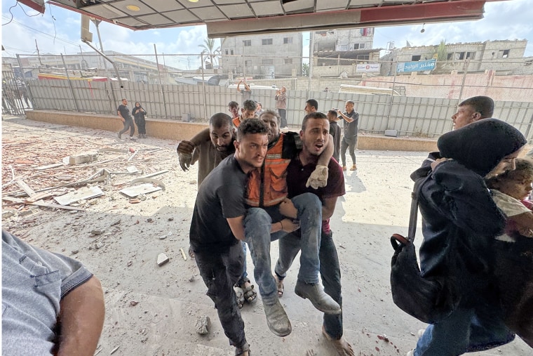 An injured Palestinian is carried following Israeli attacks on the Nasser Medical Complex in Khan Younis, Gaza, on Aug. 25, 2025. 